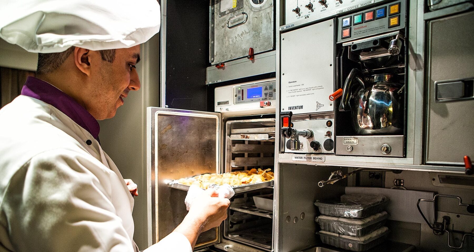 Turkish Airlines Inflight Chef prepares dishes in oven