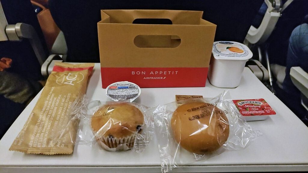 A tray of food and drinks on a plane.